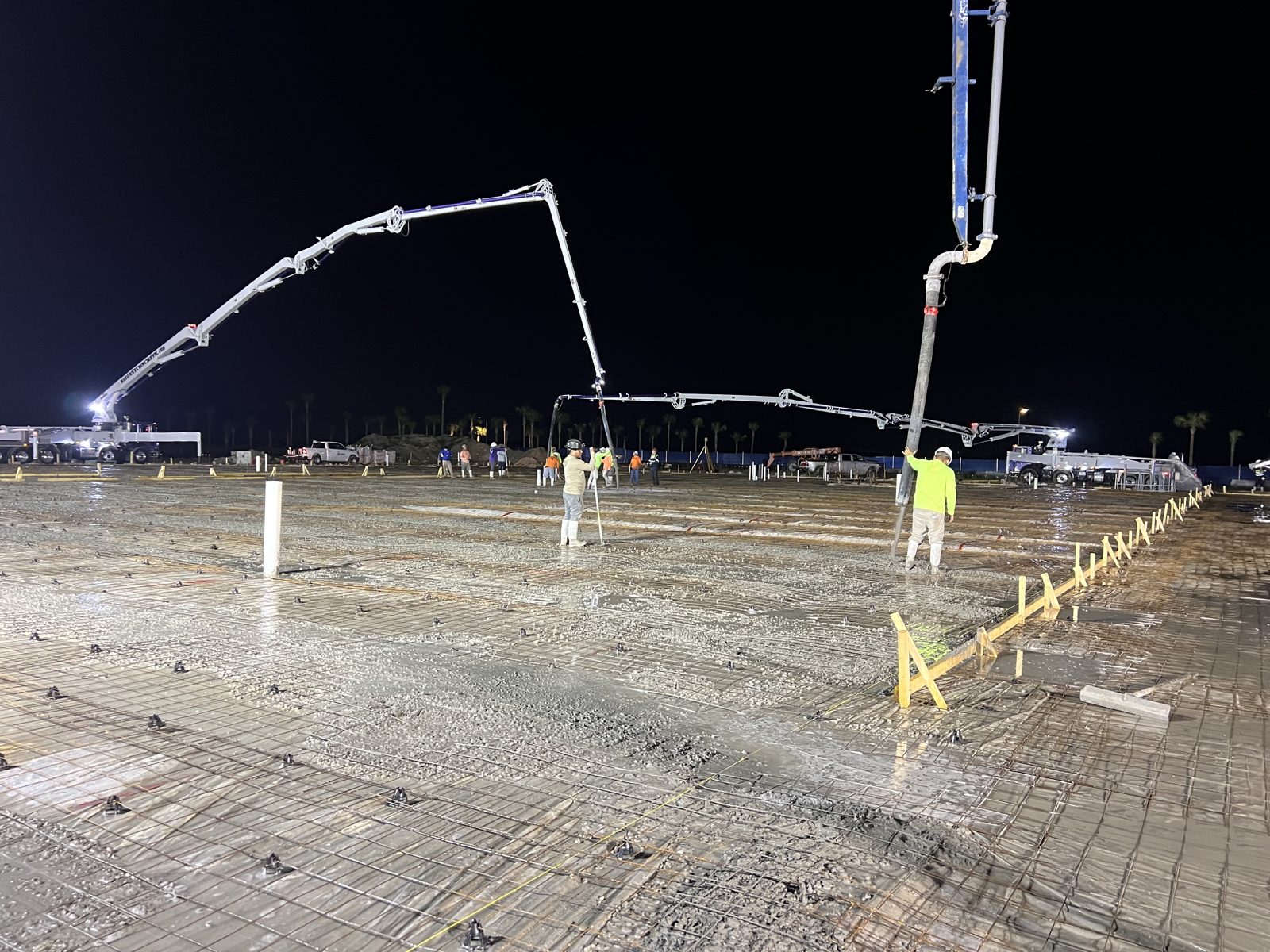 Fresh concrete placed over the rebar mat on a commercial slab pour