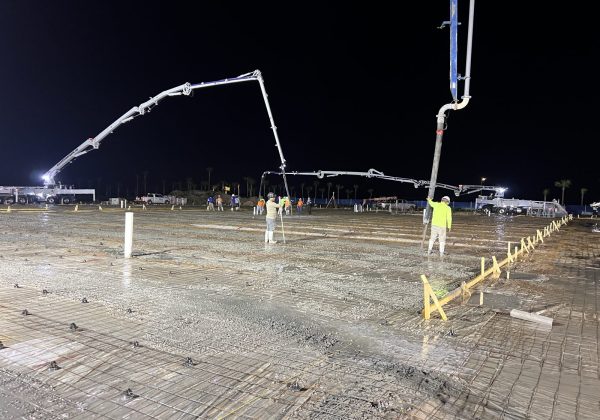 Fresh concrete placed over the rebar mat on a commercial slab pour